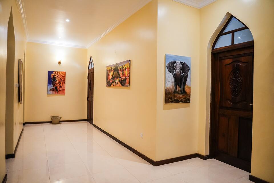 Corridor with African art and carved Zanzibari door
